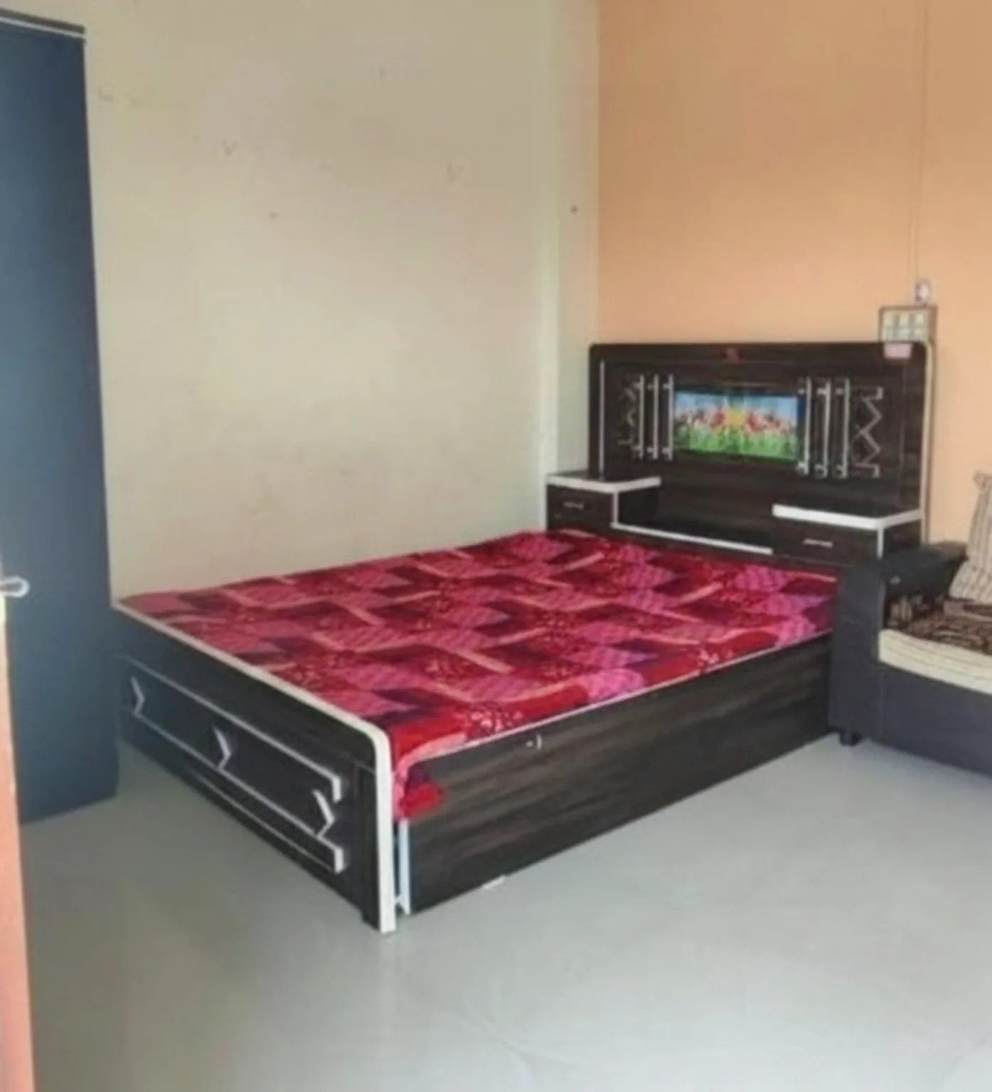 Clean spacious bedroom at Atithi Niwas Jejuri near Khandoba Temple